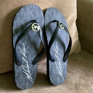 MK black rubber flip flops